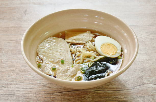 shoyu ramen or Japanese yellow noodles topping slice braised pork and boiled egg  in soy sauce soup