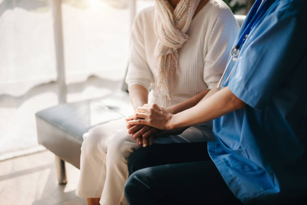 istock Close up view of old woman leaning on nurse while siting 1492888725