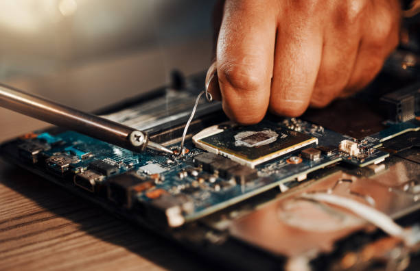 istock Information technology hands, motherboard soldering and man repair hardware circuit, electronics or semiconductor. CPU system maintenance, service industry and IT worker fixing microchip in tech lab 1492888913
