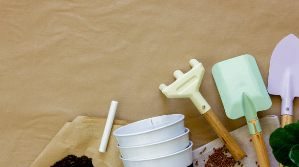 istock Garden tools, pots and soil and on table, top view. Copy space. 1492889034