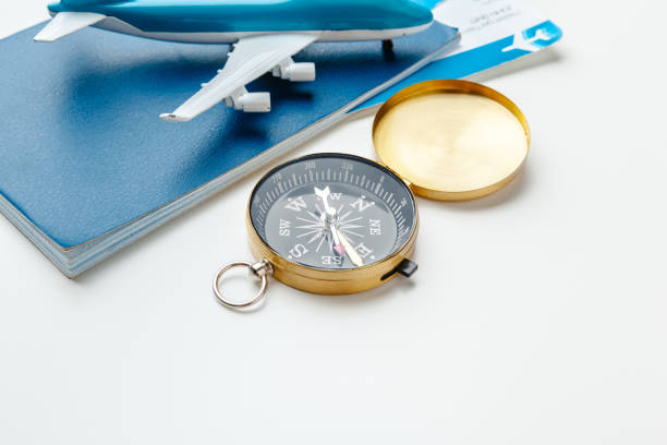istock Time to Travel. Idea for tourism with flight tickets and compass on white 1492892117