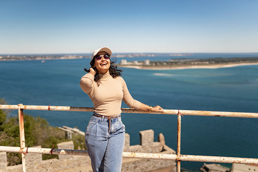 Model posing for photo overlooking the sea in Setúbal, Portugal