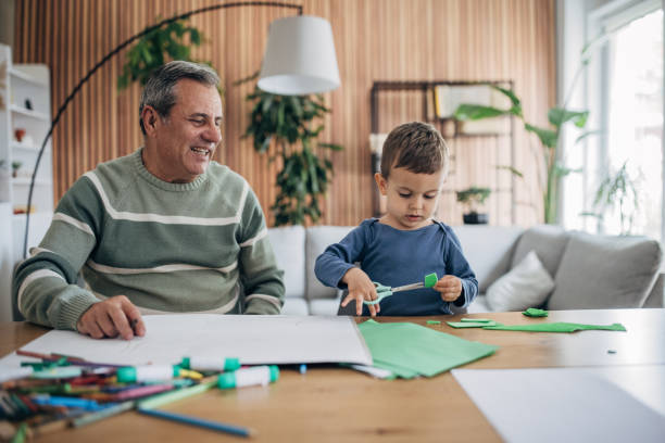 istock At home, grandfather and grandson are playing 1492897885
