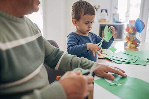 At home, grandfather and grandson are playing