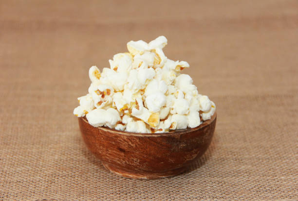 istock White fried airy popcorn in  plate on a brown background 1492901113