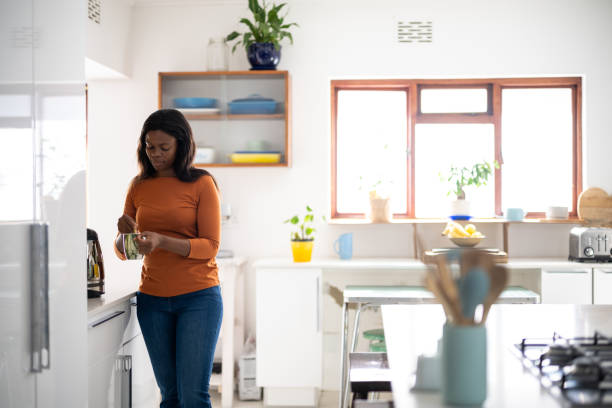 istock Woman making her coffee in the kitchen 1492903665