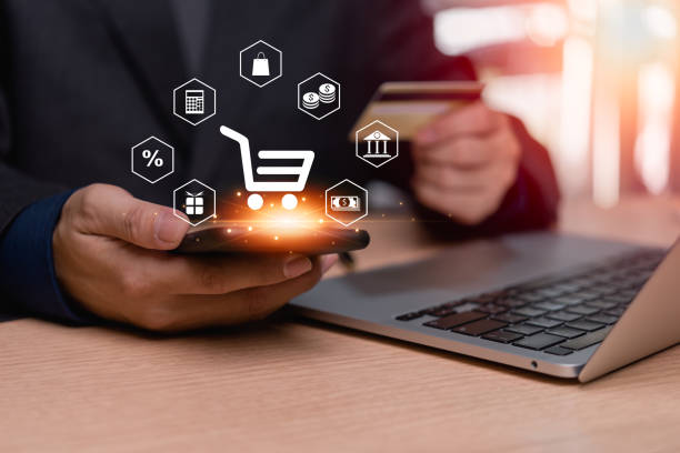 istock man using smartphone shopping online and e-commerce icon on screen mobile phone. purchase payment on internet. Digital marketing and financial banking. 1492905272