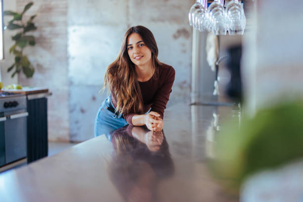 istock Young woman leaning on kitchen counter. 1492906382