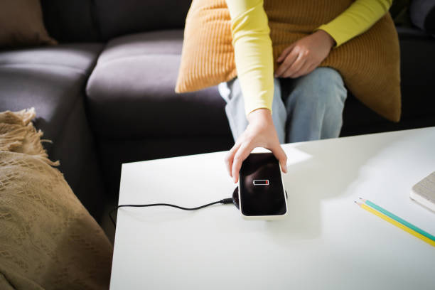 istock Charging mobile phone battery with wireless charging device in the table. Smartphone charging on a charging pad. Mobile phone near wireless charger Modern lifestyle technology concept. 1492909640