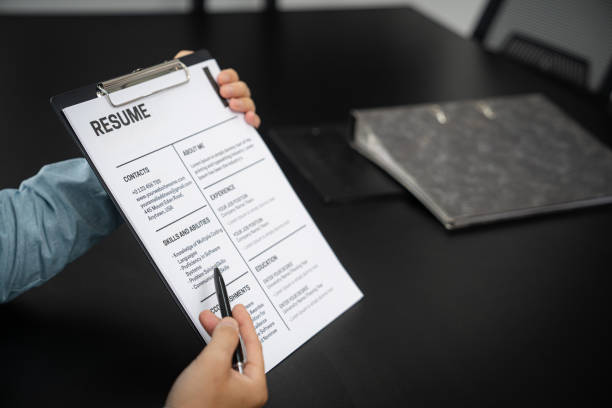 istock Examiner reading a resume during job interview at office Business and human resources concept. 1492910520