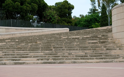 Stairs leading up towards a park with trees