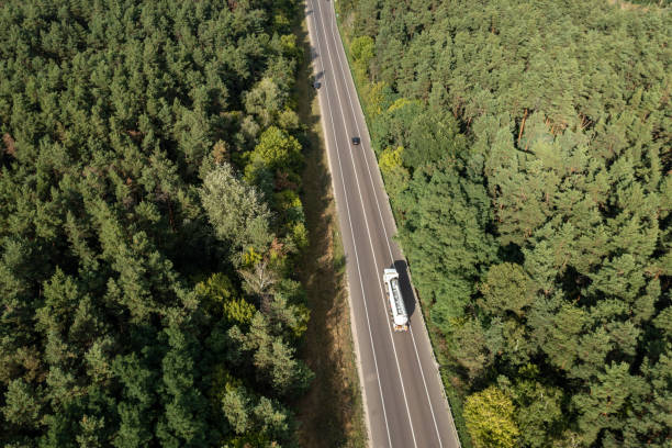 istock Tank truck on highway going through summer forest 1492914930