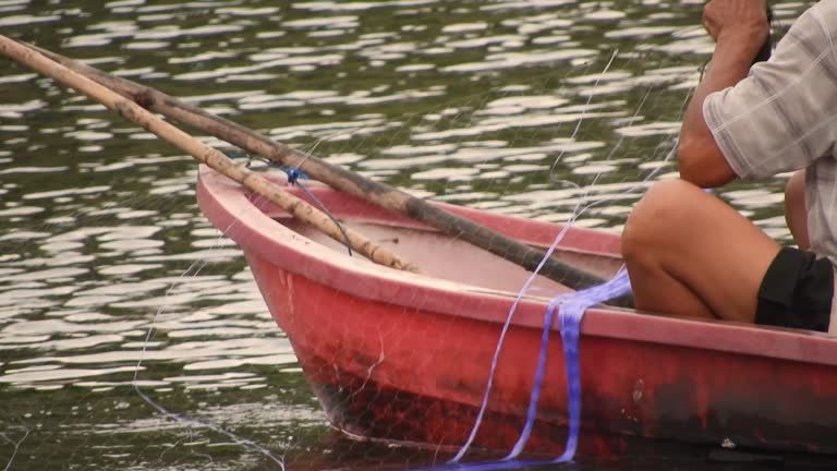 Fishermen use boats to fish in a lake in Thailand,