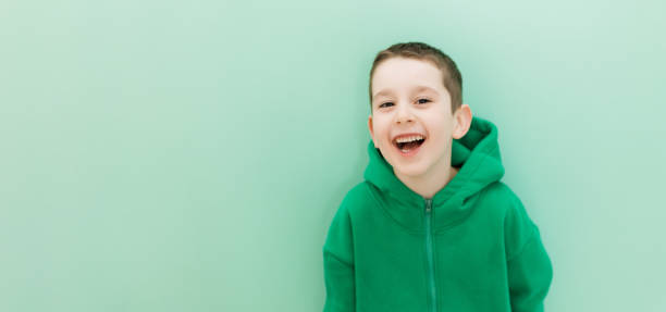 istock Caucasian boy in green hoodie copyspace 1492917125