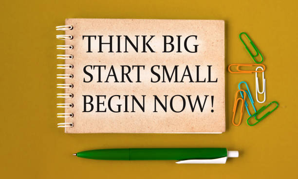 istock THINK BIG START SMALL BEGIN NOW! - words on a gray notebook with pen and paper clips 1492917260