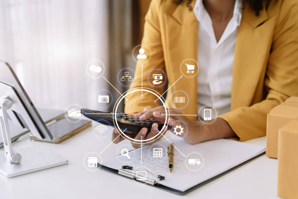 istock Entrepreneur using calculator calculating financial expense at home office, online market packing box delivery,Startup successful small business owner, SME, concept. 1492918440