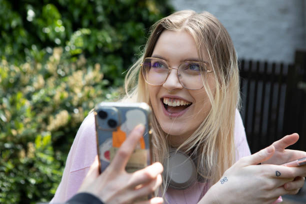 istock Young female laughing with a smart phone 1492919459