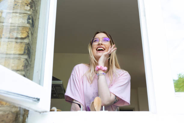 istock One young female calling out of a kitchen window 1492919627