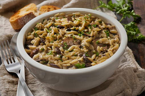 Rigatoni pasta with four cheese sauce, mushrooms, walnuts and spinach