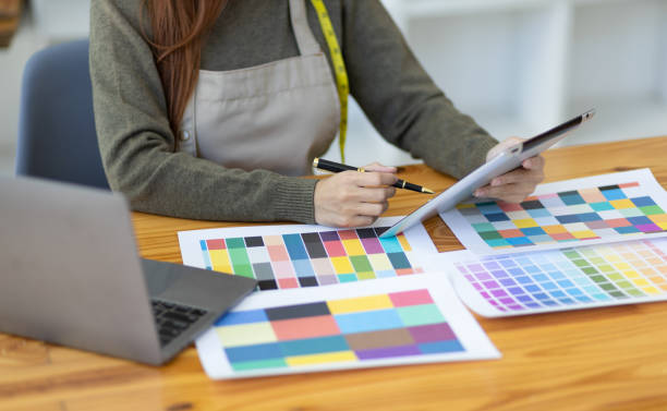 istock Fashion designer in design studio working with laptop and fabric color samples on desk. Entrepreneurship Ideas Starting a Small Business 1492924321