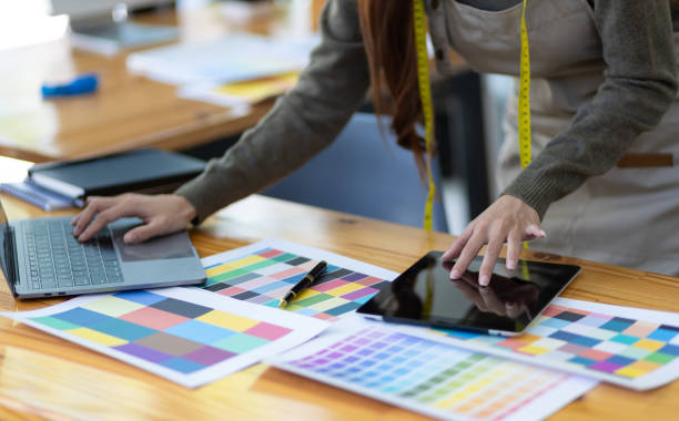 istock Fashion designer in design studio working with laptop and fabric color samples on desk. Entrepreneurship Ideas Starting a Small Business 1492924335