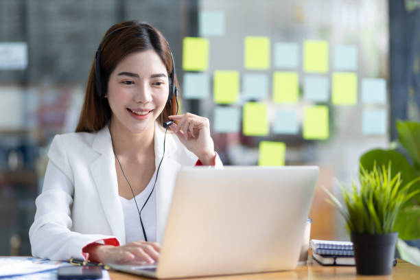 istock Telephone operator or customer service representative working in a call center office. 1492924526