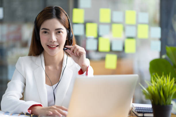istock Telephone operator or customer service representative working in a call center office. 1492924532