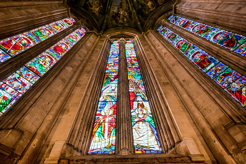 A view of the splendid interior of the Duomo in the medieval heart of Arezzo in Tuscany. Officially named as the Cattedrale dei Santi Pietro e Donato (Cathedral of Saints Peter and Donato), the Duomo of Arezzo was built starting from 1278 in the Gothic style. The interior has three naves covered with cross vaults and divided by round Gothic arches. Inside are kept works by Donatello, Piero della Francesca and Guillaume de Marcillat, the latter author of numerous stained glass windows and rose windows and the frescoes on the vault. Arezzo, founded in Etruscan times and later becoming an important center of Ancient Rome, is famous for the innumerable artistic and architectural treasures of its medieval and Renaissance heart. Wide angle image in high definition quality.