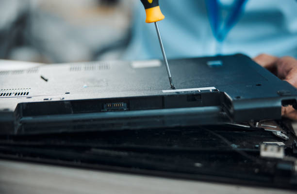 istock Laptop, technician and fixing with screwdriver, technology maintenance and repair hardware of pc. Tech support person with tools and upgrade, technical problem and electronics, digital and zoom 1492930067