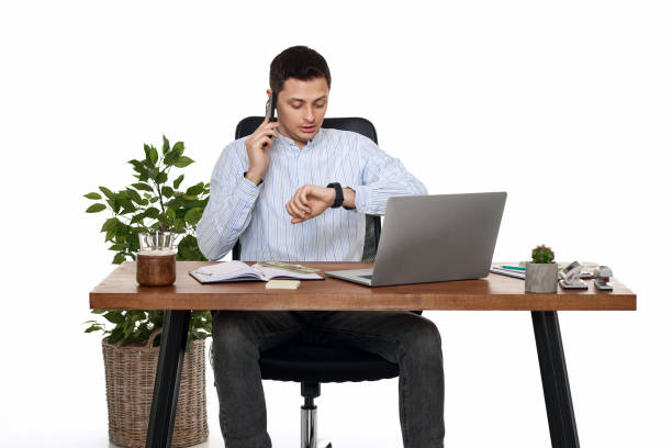 businessman working with laptop and having phone conversation