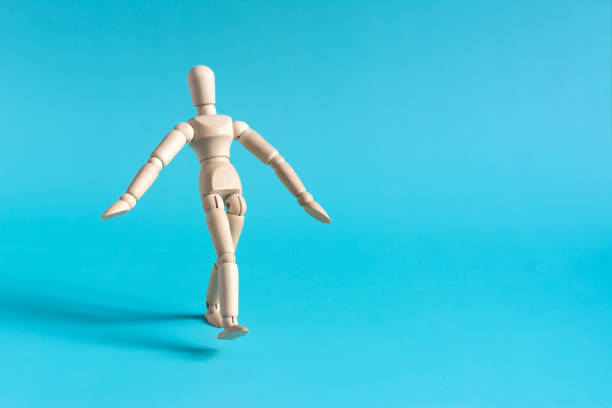 istock A cautious person takes a step forward. The wooden doll takes a step. 1492932726