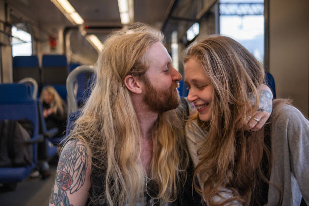 istock Lovely young couple on the train home 1492934812