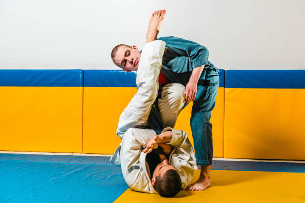 istock Brazilian jiu-jitsu and grappling training for men in a self-defense gym 1492936921