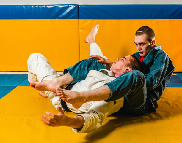 istock Brazilian jiu-jitsu and grappling training for men in a self-defense gym 1492937043
