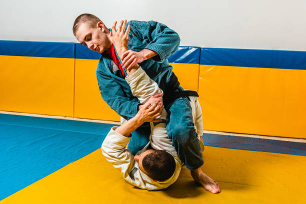 istock Brazilian jiu-jitsu and grappling training for men in a self-defense gym 1492937046