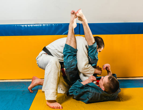 istock Brazilian jiu-jitsu and grappling training for men in a self-defense gym 1492937065