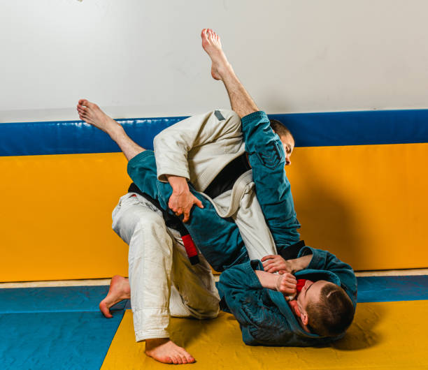 istock Brazilian jiu-jitsu and grappling training for men in a self-defense gym 1492937066