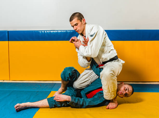 istock Brazilian jiu-jitsu and grappling training for men in a self-defense gym 1492937069