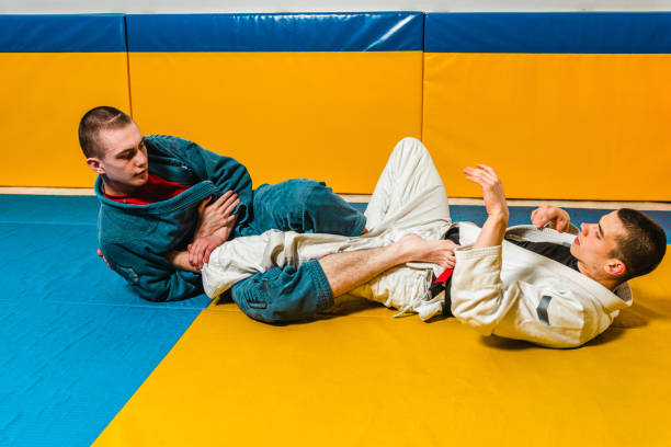 istock Brazilian jiu-jitsu and grappling training for men in a self-defense gym 1492937104