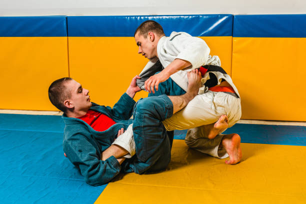 istock Brazilian jiu-jitsu and grappling training for men in a self-defense gym 1492937128