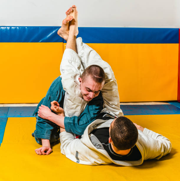 istock Brazilian jiu-jitsu and grappling training for men in a self-defense gym 1492937295