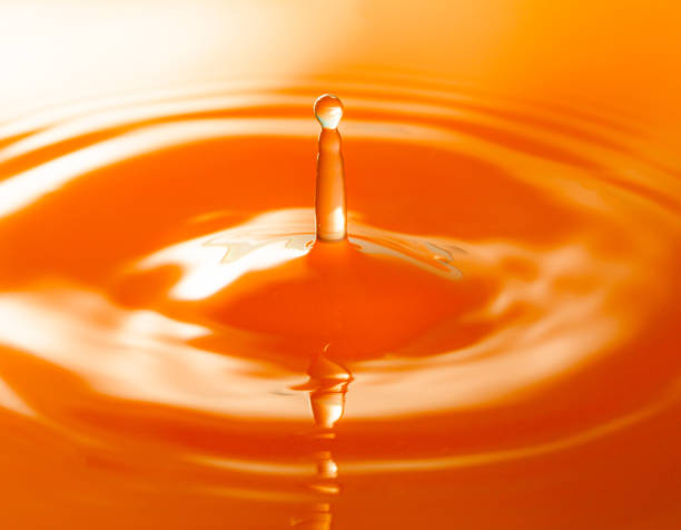 istock Macro orange drop,Macro orange water drop texture,Falling drop in orange water with splash,The waves after a few drops of orange juice. 1492939162