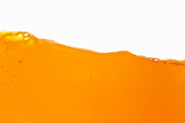 istock Orange juice isolated white background,orange juice texture on white background,Close up bright orange juice texture for health and nature waves 1492939242