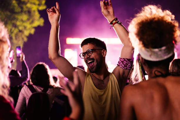 istock Cheerful man dancing at music festival 1492940740