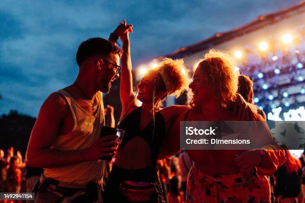 Friends Having Fun Drinking Beer And Dancing At Concert Stock Photo - Download Image Now