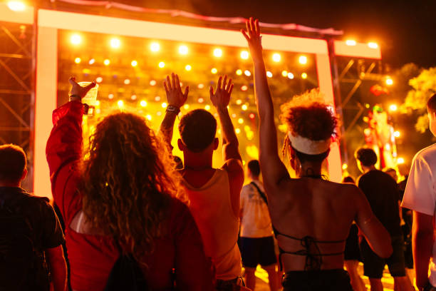 Young friends in an audience enjoying their favorite band's performance.