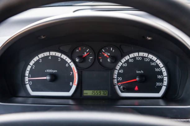 istock Car dashboard with red instrument circles with backlit arrows at night with a speedometer, tachometer with a mechanical gearshift gearbox to monitor the condition of the car on a black background. 1492942820