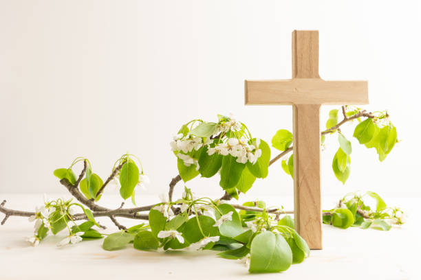 istock Wood cross with branch with white blossoms 1492942903