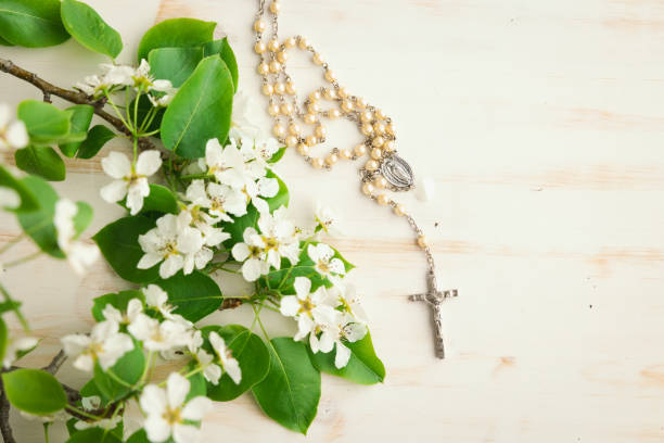Rosary and white flower blossoms stock photo