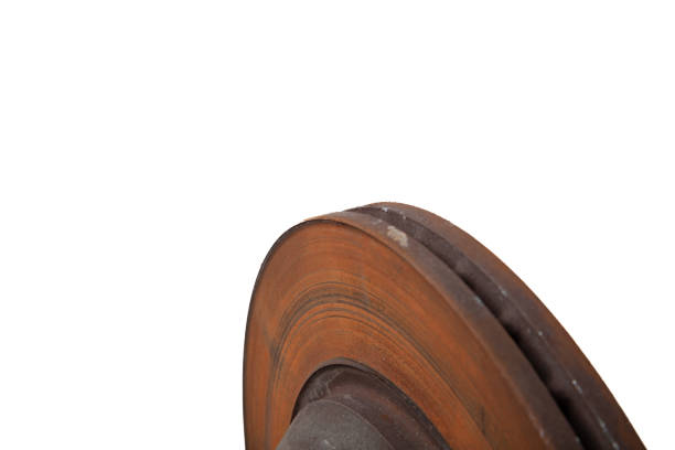 istock Old brake discs covered with rust on a white isolated background in a photography studio. Seasonal repair of suspension and brake system in workshop or sale of spare parts for auto analysis. 1492943626